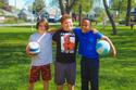 three school age boys with volley balls